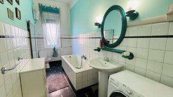 Bathtub, hair dryer, bidet, towels