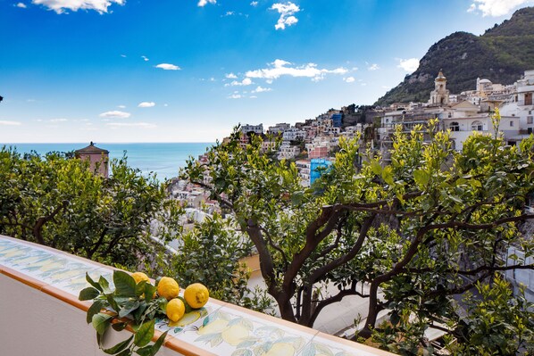 A coastal town with buildings on a hillside overlooking the sea.