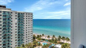 A high-rise hotel overlooking a beach with a pool and palm trees. - Beach front 2/1.5 luxuriously renovated space NEW! Rare find ... (Hollywood)