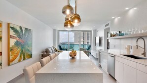 A modern kitchen with a central island, stainless steel appliances, and a view to the outside. - Beach front 2/1.5 luxuriously renovated space NEW! Rare find ... (Hollywood)