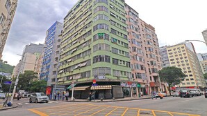 A multi-story building with balconies, a McDonald's sign, and a visible storefront.