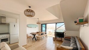 A modern living space with a kitchen, dining area, and seating area. - Ultimate Ocean View El Cotillo (El Cotillo)