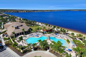 A resort with a large central pool, multiple smaller pools, and a beach area. - Condo in Quarry Resort Community (Naples)