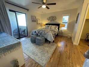 A bedroom with a bed, a ceiling fan, a window, and a door. - Cozy Home/ASU/Spring Training/Restaurants & More (Tempe)