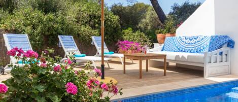 An infinity pool, sun loungers