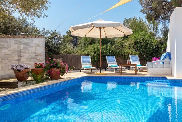 An infinity pool, sun loungers