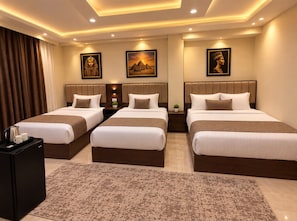 A hotel room with three beds, a coffee machine, and a small refrigerator. - ZEINA PYRAMIDS VIEW HOTEL (Giza)