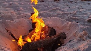 A beach scene with a fire burning in the sand at sunset. - 🏖️1st Row Beach House🌴6 Seat Golf Cart 🌊OceanView Pools🏝️Beach Equip🔥Patio-Firepit (Port St. Joe)