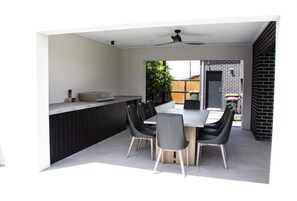 Enjoy meals and social gatherings in this spacious living area with a large dining table and four chairs.