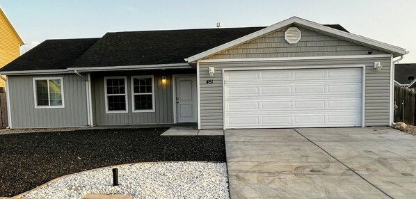 A single-story house with a garage, a front porch, and a driveway.
