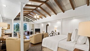 A spacious bedroom with a large bed, two armchairs, a wooden ceiling, and a view of the outdoors. - Meyer Hotel (Comfort)