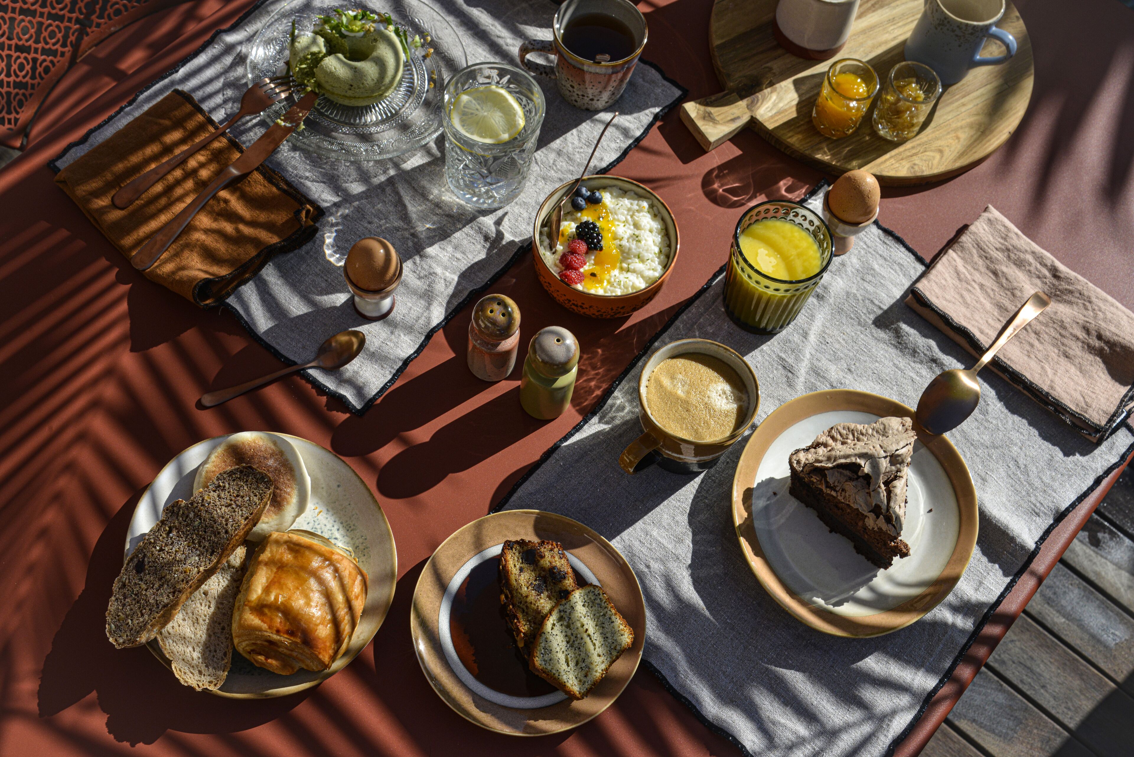 A breakfast spread with various foods and drinks on a table.