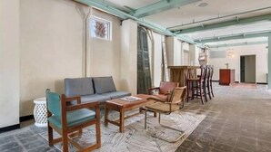 A spacious living area with a sofa, chairs, and a coffee table.
