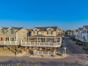 A coastal residential area with houses featuring balconies and a waterfront view. - July 11-18 Cancellation Discount! Oceanfront Home with Direct Beach Access! (Myrtle Beach)