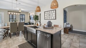 A modern kitchen with a central island, stainless steel appliances, and pendant lighting. - Unique and Secluded home, traffic-free and quite (El Paso)