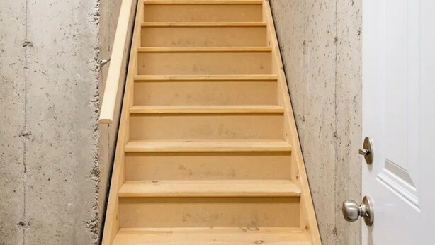 A wooden staircase leading to a white door with a window above it. - 3BR Sunshine basement w separate entrance Waterloo (Waterloo)
