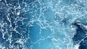 A close-up of ocean waves with white foam.