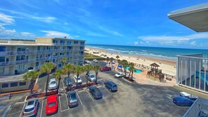 A beachfront hotel with a parking lot, beach view, and a pool area. - Sea Dip Resort Studios (Daytona Beach)
