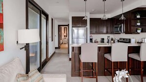 A modern kitchen with a central island, stainless steel appliances, and pendant lighting. - 360 Splendor 406-Condo with Breakfast Included (360 Splendor)
