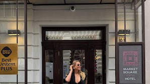 A hotel entrance with a sign reading "Best Western PLUS" and another sign for "Market Square Hotel". - Best Western Plus Market Square Lviv (Lviv)