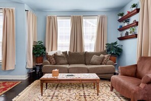 Relax in this inviting living room with a comfortable sofa, coffee table, and plush rug.