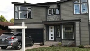 A two-story house with a garage, a driveway, and a parked car. - Modern home in downtown Sumner, WA, 34 mi from Lumen Field (Sumner)