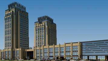 A modern building with multiple floors, large windows, and a flat roof.