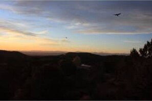 Surrounded by serene hills and sparse vegetation, this peaceful landscape offers a tranquil escape.