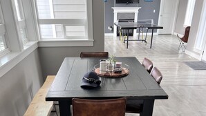 A dining area with a dark wooden table, leather chairs, and a bench. - Country Living and Views; Full RV hookup available (Moscow)