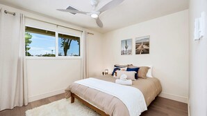 A bedroom with a bed, a ceiling fan, a window with curtains, and two wall-mounted pictures. - 3BR w/ Heated Pool! Mins from ASU and Golf! (Tempe)