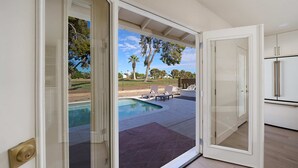 A modern kitchen with white cabinets and a stainless steel refrigerator. - 3BR w/ Heated Pool! Mins from ASU and Golf! (Tempe)