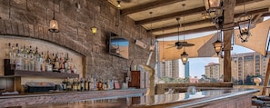 Enjoy a drink at the bar with a view of the surrounding cityscape.
