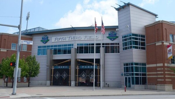 A building with 'Fifth Third Field' signage, a brick facade, and a large entrance with decorative gates.
