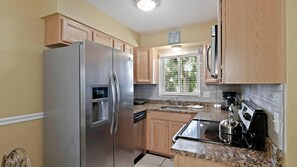 Condo, 1 Bedroom | Private kitchen | Oven, dishwasher, dining tables - The Waves by Sandy Beach Vacations (St. Pete Beach)