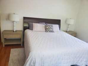 Cozy retreat with a large bed, two bedside tables, and a light-colored rug.