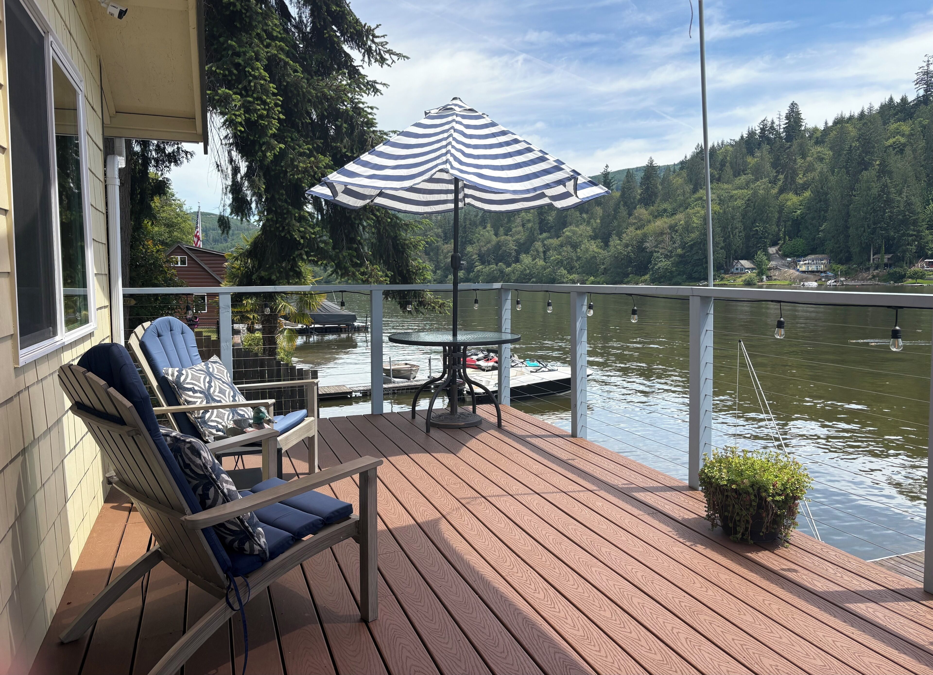 The deck extends the length of the cabin, overlooks the fire pit.