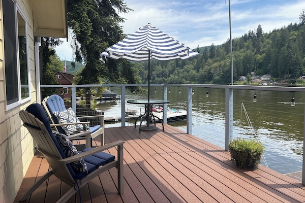The deck extends the length of the cabin, overlooks the fire pit.