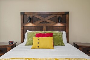 Relax in comfort with a large bed and two bedside tables, each with a lamp.