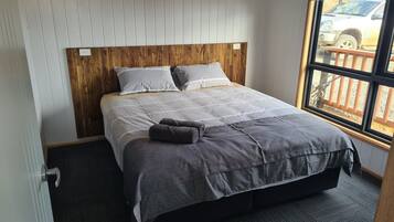 Comfortable king bedroom with a peaceful bushland setting.