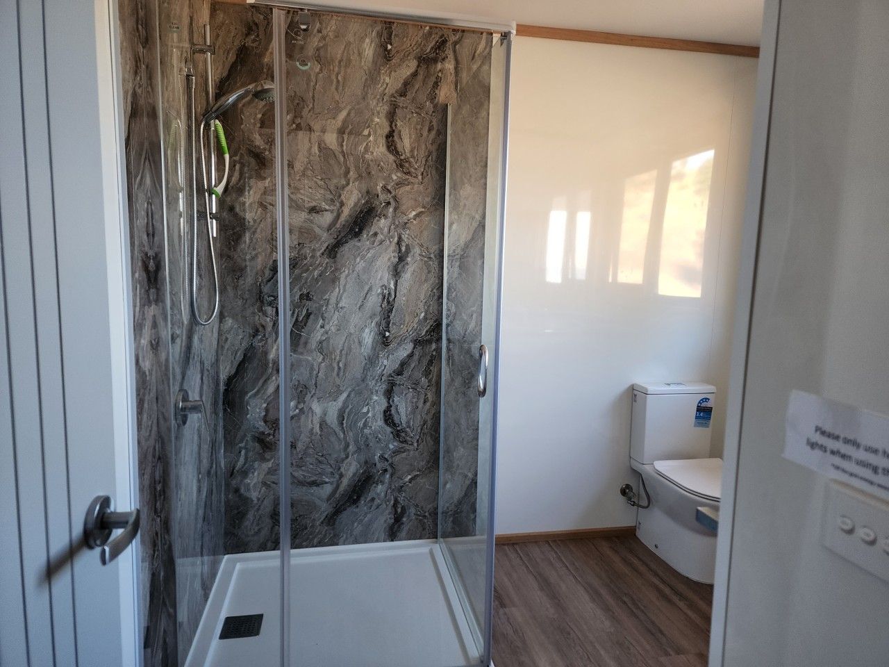 Modern bathroom with a walk-in shower and practical amenities.