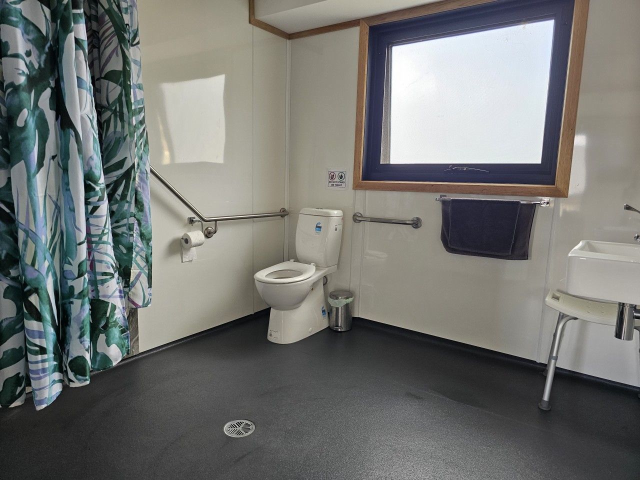 Spacious accessible bathroom with wheelchair-friendly features.
