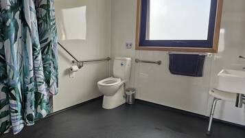 Spacious accessible bathroom with wheelchair-friendly features.