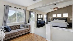 A bedroom with a bed, a nightstand, a dresser, and a window with curtains. - Luxurious spa-like oasis with pool, 4bdr/ 3br (Elk Grove)
