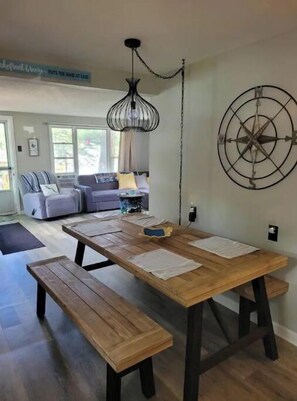 Enjoy casual dining or social gatherings in this inviting space with a wooden table and benches.