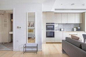 A modern apartment with a kitchen, living area, and a bathroom.