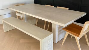 A modern dining area with a rectangular table, wooden chairs, and a bench. - Contemporary 3BR Family-Friendly Oasis Close to the Lake (Toronto)