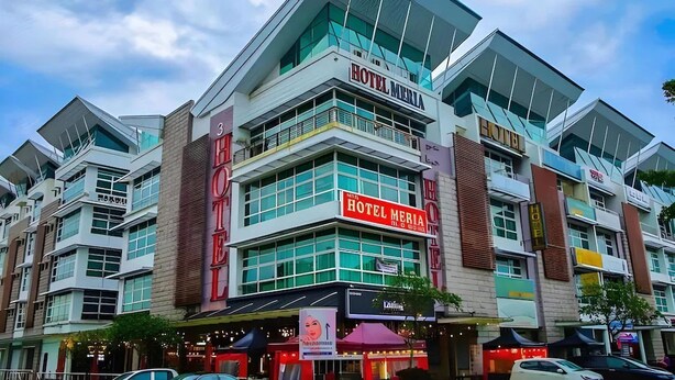 A multi-story hotel with a prominent 'HOTEL MERIA' sign, large windows, and a modern architectural design. - Collection O Shah Alam Formerly Hotel SMC Seksyen 13 (Shah Alam)