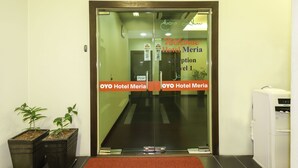 A hotel reception area with a glass door, a welcome sign, and a water dispenser. - Collection O Shah Alam Formerly Hotel SMC Seksyen 13 (Shah Alam)