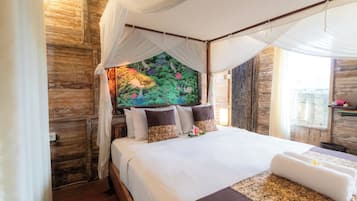 A bed with a canopy, a mural, and a view of a cityscape.