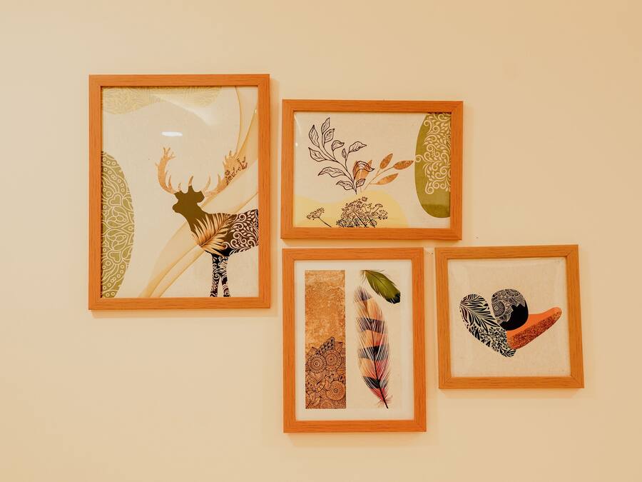 Four framed artworks on a wall.